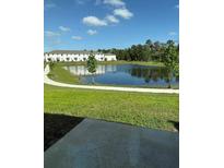 Scenic pond view surrounded by lush greenery and walking path at 7433 Stone Creek Trl, Kissimmee, FL 34747