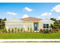 Charming single-story home featuring a well-manicured lawn and inviting front entrance with a decorative door at 1524 Covey Rise Ter, Winter Haven, FL 33884