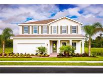 Charming two-story home with a well-manicured lawn and a classic architectural design at 1722 Upland Ln, Winter Haven, FL 33884