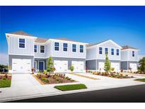 Charming townhomes featuring attached garages and landscaped front yards offer modern living and curb appeal at 2303 Incandescent Way, South Daytona, FL 32119