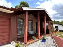 Inviting front porch with brick pillars and decorative landscaping welcomes you home at 14545 Sw 34Th Terrace Rd, Ocala, FL 34473