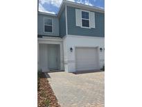 Charming two-story townhome with a one car garage and landscaped front yard at 1129 Red Buckeye Ct, Deland, FL 32720