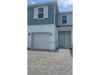 Charming two-story home featuring a one car garage and a neatly paved driveway at 1133 Red Buckeye Ct, Deland, FL 32720