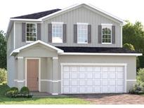 Charming two-story home featuring a light gray exterior, complemented by a two-car garage and well-maintained landscaping at 6408 Domizio Dr, Winter Haven, FL 33884