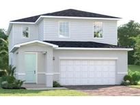 Charming two-story home with white siding, a covered entryway, and an attached two-car garage at 6505 Domizio Dr, Winter Haven, FL 33884