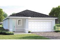 Charming single-story home featuring a two-car garage and freshly landscaped front yard at 6509 Domizio Dr, Winter Haven, FL 33884