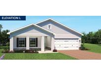 Charming single-story home with a two-car garage, well-manicured lawn, and inviting front porch at 1373 Laramie Way, Haines City, FL 33844