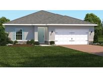 Charming single-story home with a manicured lawn and a two-car garage, offering curb appeal at 1408 Laramie Way, Haines City, FL 33844