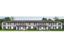 Newly constructed townhomes with modern gray siding, a brown roof, and well-manicured landscaping at 761 Mystic Gardens Dr, Apopka, FL 32703