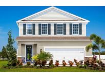 Charming two-story home with landscaped yard and a two-car garage at 1156 Ivy Manor St, Minneola, FL 34715
