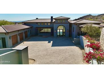 Stunning home exterior with tile roof, arched entry, and spacious driveway at 6825 N 39Th Pl, Paradise Valley, AZ 85253