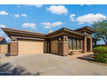 Beautiful single-Gathering home featuring a three-car garage, stone accents, and a well-maintained front yard at 12797 S 179Th Dr, Goodyear, AZ 85338