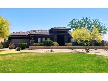 Single-story home with well-manicured lawn and desert landscaping, offering great curb appeal at 12797 S 179Th Dr, Goodyear, AZ 85338