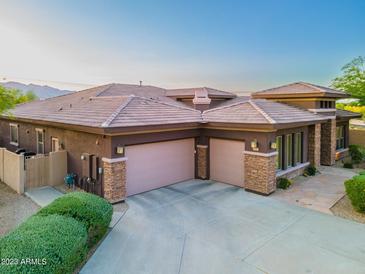 Rear exterior featuring three garage doors and desert landscaping at 12797 S 179Th Dr, Goodyear, AZ 85338