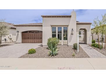 Charming single-story home with a desert-landscaped front yard and a stylish brown garage door at 578 E Las Puertas Ln, Queen Creek, AZ 85140