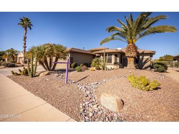 Single-story home with desert landscaping and two-car garage at 17156 W Lachlan Ct, Surprise, AZ 85387