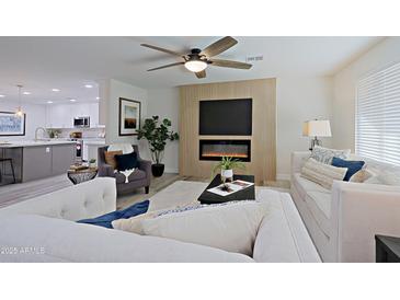 Bright living room with fireplace and open floor plan at 17407 N 130Th Dr, Sun City West, AZ 85375