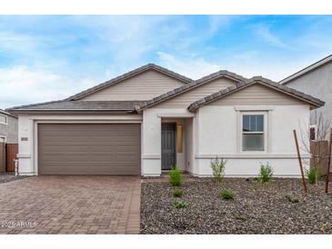Charming single-story home featuring a well-maintained front yard and a two-car garage at 18795 E Elizar Dr, Gold Canyon, AZ 85118
