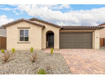 Charming single-story home featuring a tile roof, stucco finish, and a well-manicured front yard at 18740 E Elizar Dr, Gold Canyon, AZ 85118