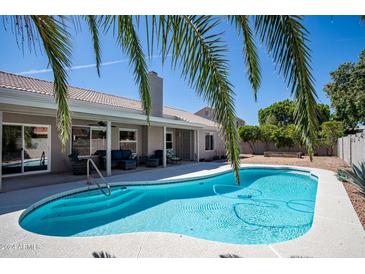 Inviting backyard pool featuring cool, clear water and surrounding patio, great for outdoor relaxation and entertaining at 1660 N 59Th St, Mesa, AZ 85205