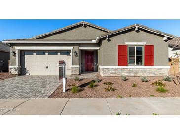 Single-story home with gray exterior, red shutters, and a paved driveway at 16400 W Avenida Del Sol --, Surprise, AZ 85387