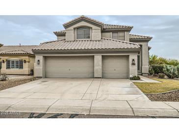 Charming two-story home showcasing a desert landscape and a three-car garage at 4803 E Barwick Dr, Cave Creek, AZ 85331