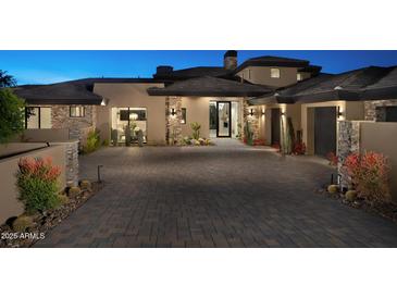 Stunning home exterior with stone accents and a large driveway at 29646 N 109Th Pl # 128, Scottsdale, AZ 85262