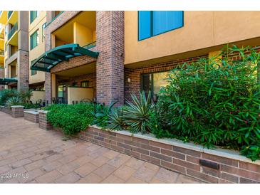 Brick building exterior with lush landscaping and a well-maintained walkway at 16 W Encanto Blvd # 112, Phoenix, AZ 85003