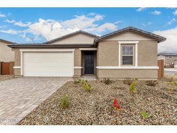 Charming single-story home featuring a two car garage, neutral color palette, and low maintenance landscaping at 18812 E Elizar Dr, Gold Canyon, AZ 85118