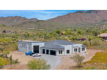 Stunning aerial view of a modern home with a detached garage, showcasing a desirable location at 6501 E Willow Springs N Ln, Cave Creek, AZ 85331