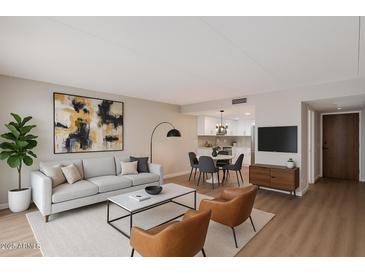 Bright living room featuring modern furnishings, wood floors, and an open floor plan at 7930 E Camelback Rd # 506, Scottsdale, AZ 85251