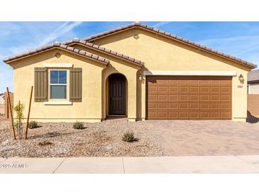 New single-story home with a two-car garage and desert landscaping at 21614 N Daniel Dr, Maricopa, AZ 85138