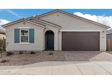 One-story home with two-car garage and neutral color palette at 40503 W Wade Dr, Maricopa, AZ 85138