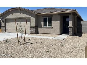 Charming single-story home with a neutral exterior and a well-maintained front yard at 24585 W Alta Vista Rd, Buckeye, AZ 85326