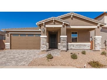 New construction home with stone accents and two-car garage at 40500 W Wade Dr, Maricopa, AZ 85138