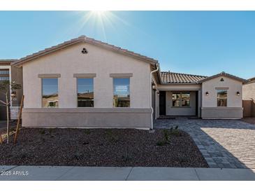 One-story home with light-colored exterior, a paved driveway, and landscaping at 16355 W Avenida Del Sol --, Surprise, AZ 85387