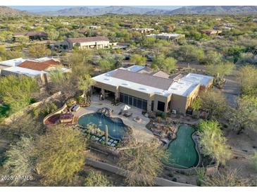 Beautiful backyard oasis, featuring a sparkling pool, spa, and putting green at 8167 E Sand Flower Dr, Scottsdale, AZ 85266