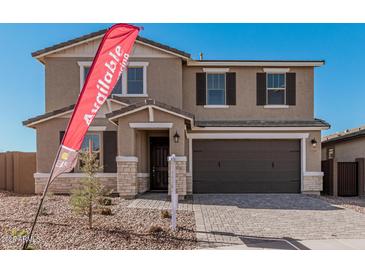 Two-story house with a brown garage door and stone accents at 11530 S 50Th Ln, Laveen, AZ 85339