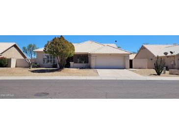 Single-story home with a two-car garage and desert landscaping at 2605 N 133Rd Ave, Goodyear, AZ 85395