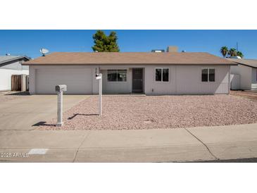 Charming single-story home with a well-maintained exterior and desert landscaping, plus an attached one car garage at 3222 W Wagoner Rd, Phoenix, AZ 85053