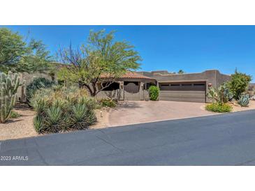 Spanish-style home with a large driveway and desert landscaping at 1710 E Staghorn Ln, Carefree, AZ 85377