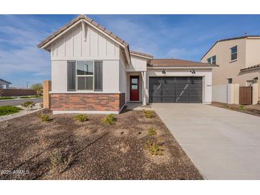 Craftsman style home with brick accents and a two-car garage at 17990 W Long Lake Rd, Goodyear, AZ 85338