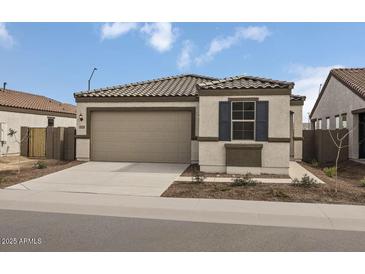 Charming single-story home with a tile roof, a two-car garage, and low-maintenance landscaping at 5729 S 243Rd Dr, Buckeye, AZ 85326