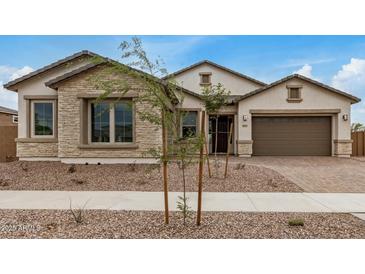 Charming single-story home featuring stone accents, neutral stucco, and a well-manicured front yard at 19679 E Estrella Rd, Queen Creek, AZ 85142