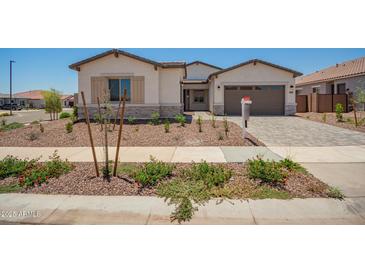 Charming single-story home featuring desert landscaping, a paved driveway, and a neutral color palette at 17225 W Calle Lejos --, Surprise, AZ 85387