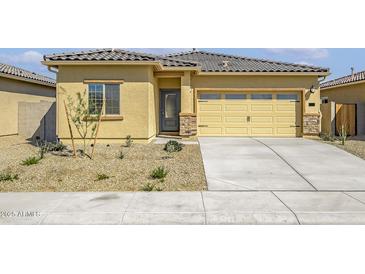 Charming single-story home with a well-manicured gravel front yard and attached two car garage at 24624 W St Catherine Ave, Buckeye, AZ 85326
