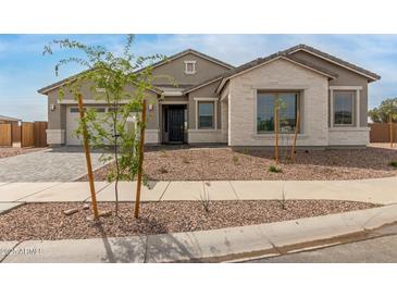Charming single-story home showcasing a stone facade and well-maintained landscaping in a peaceful neighborhood at 19539 E Estrella Rd, Queen Creek, AZ 85142