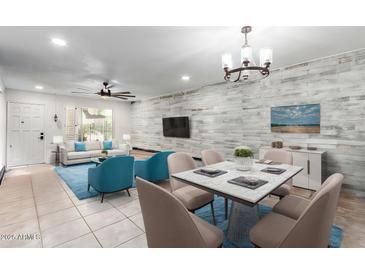 Bright living room features wood-like wall, dining area, and comfy seating at 4701 N 68Th St # 129, Scottsdale, AZ 85251