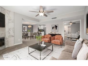 Open living room featuring neutral tones, modern furnishings, and seamless flow into dining and kitchen areas at 9275 E Mission Ln # 215, Scottsdale, AZ 85258