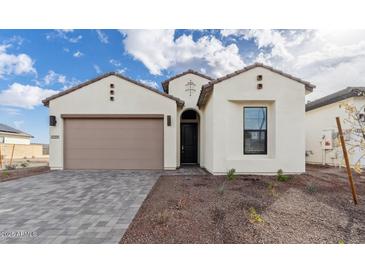Stunning home featuring a neutral palette, an attached two-car garage, and an easy to maintain xeriscaped front yard at 4359 N 203Rd Ave, Buckeye, AZ 85396